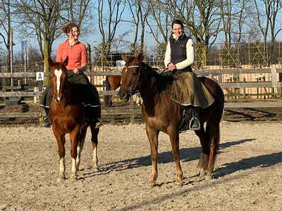 Two lady's both riding in there Original Moorland riding skirts in the sunshine, in a sandschool.
