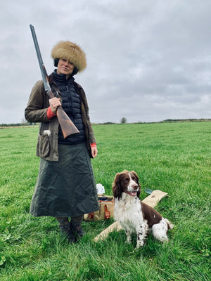 Customer out in the field with her waterproof shooting skirt, shotgun and springer spainel set ready for a days shooting.