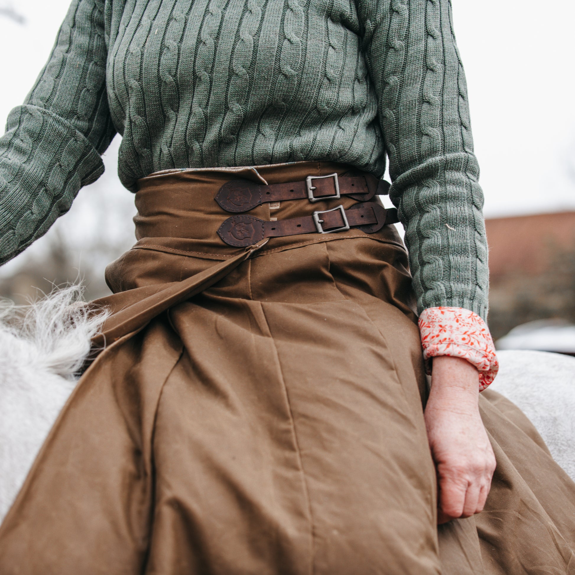 Close up of buckles on the side of our handcrafted riding habit, showing our unique split design.