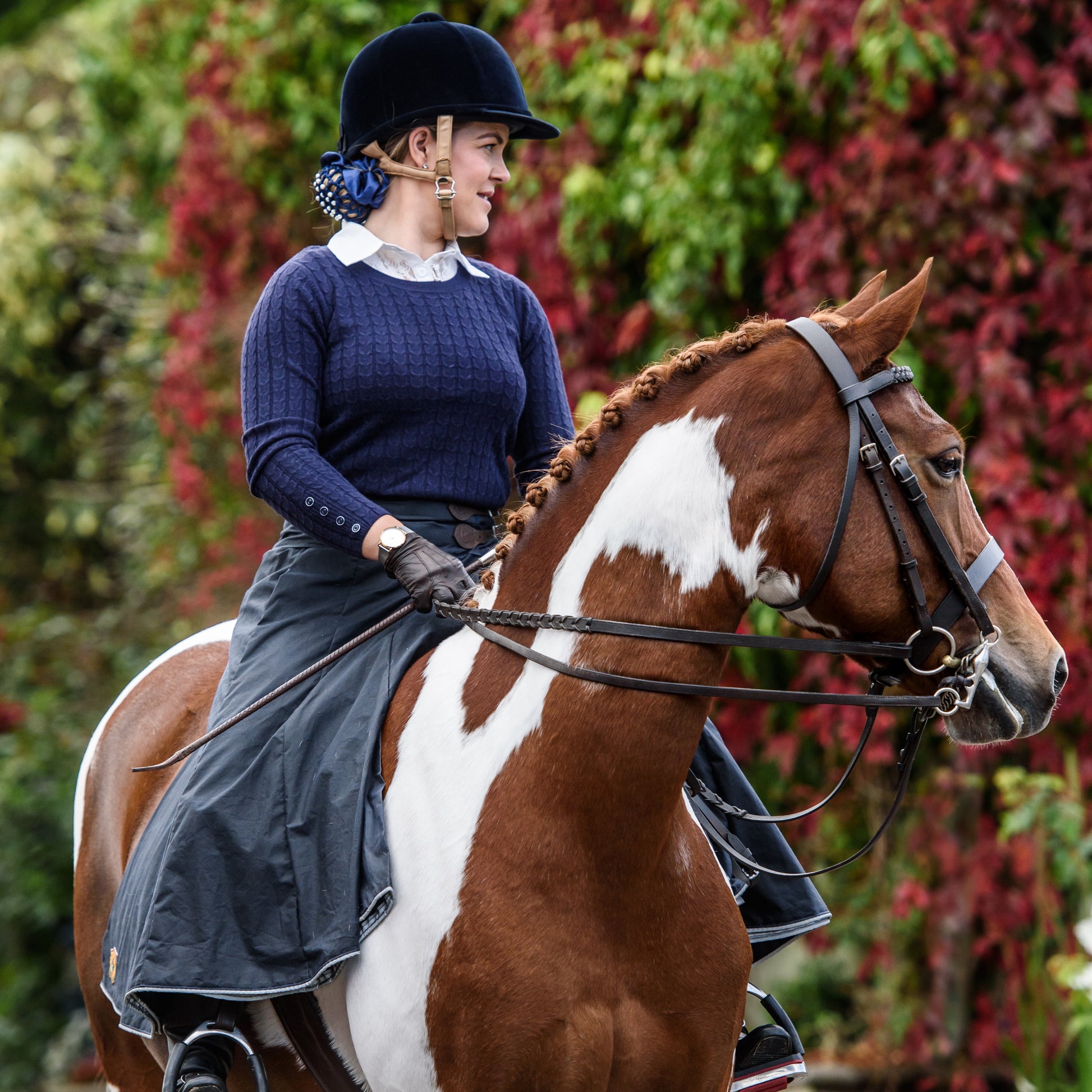 British-made riding habit on horse back stood in front of some autumn leaves