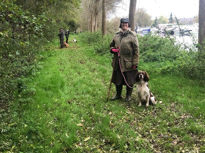 Customer wearing a bespoke Compass waterproof habit, while out beating with her springer spainel.
