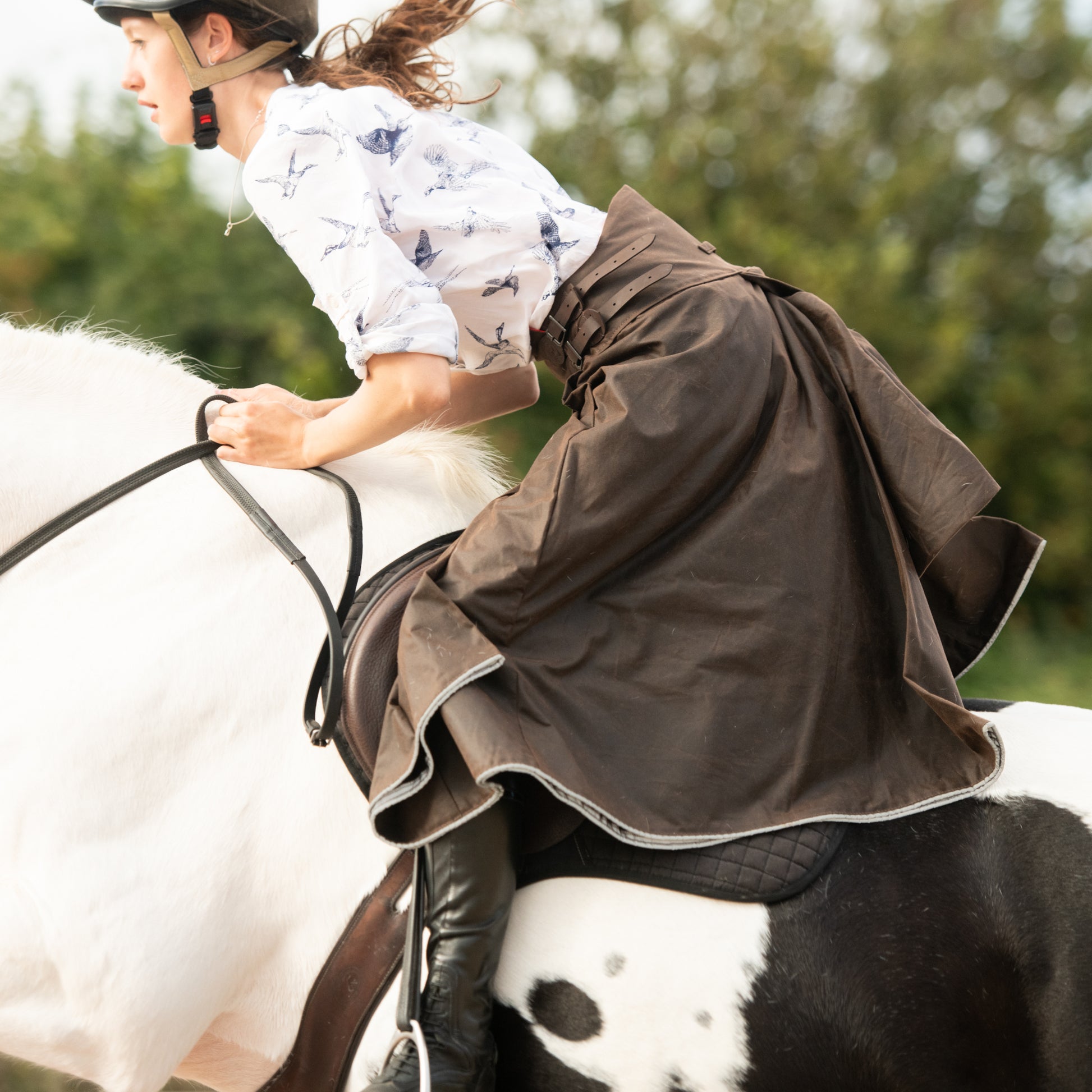 Handcrafted riding habit being worn while show jumping.