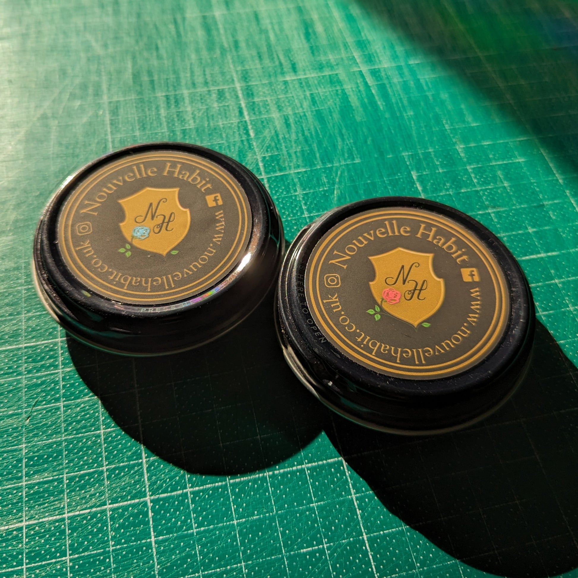 two wax pots with the sun behind them in the workshop.